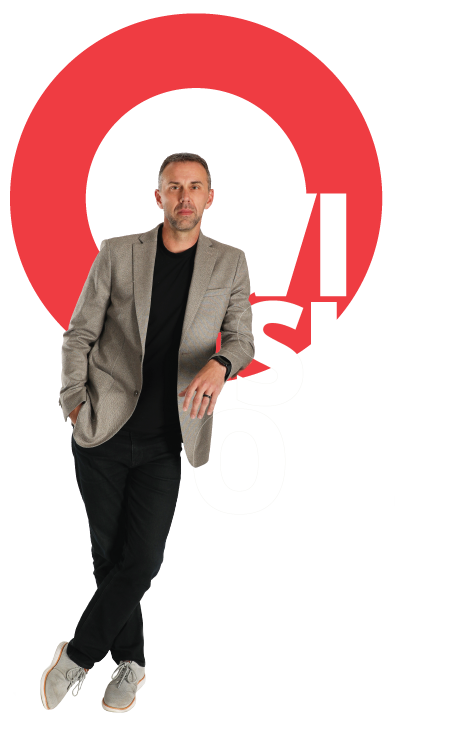 A man leaning in front of a graphic that reads, "vision"